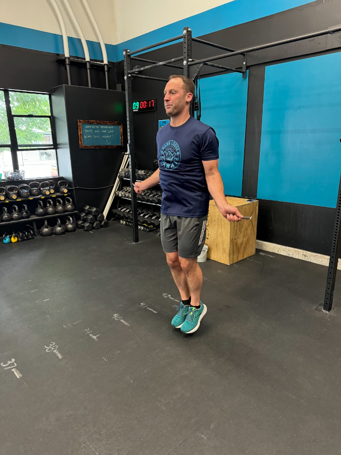 A man is jumping a jump rope in Portland, OR's best CrossFit gym.