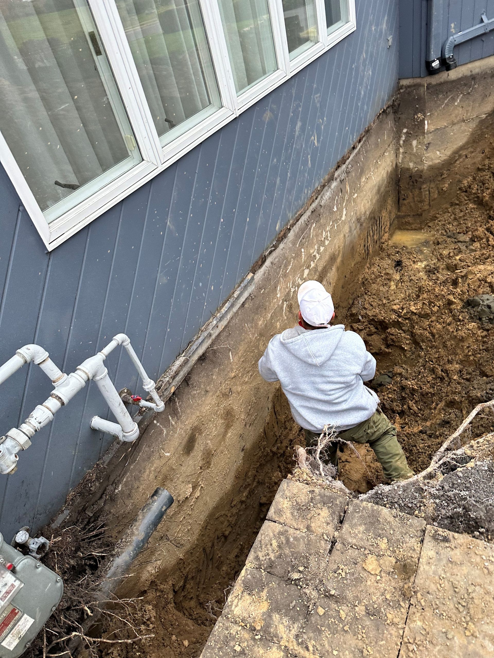 Man Digging A Hole — Monmouth and Ocean Counties — Total Home Renovation