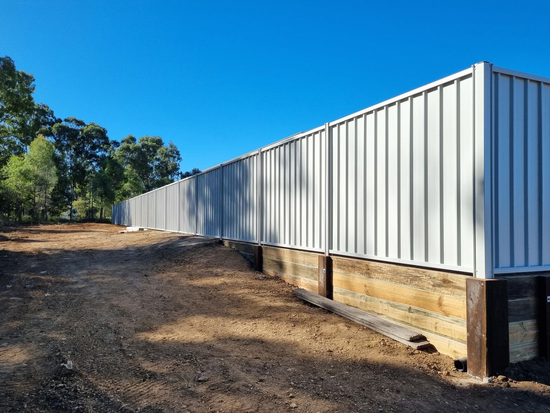 A Wooden Deck With a Pergola and Wicker Furniture — RBG Building & Maintenance in Veteran, QLD