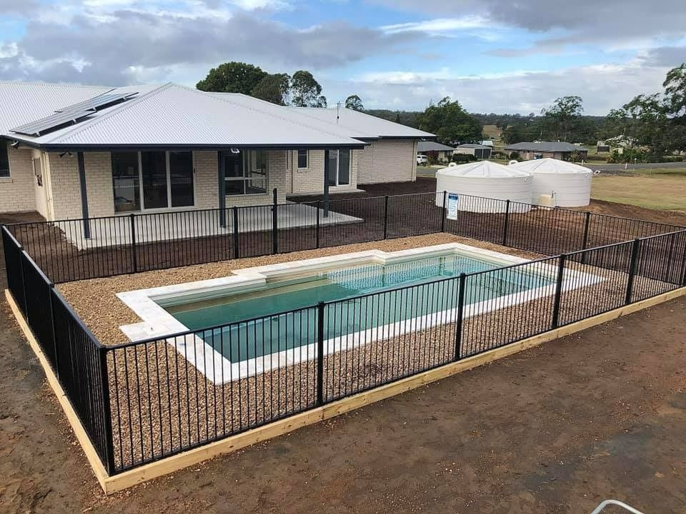 A White House With a Swimming Pool and Fence — RBG Building & Maintenance in Cooloola Cove, QLD