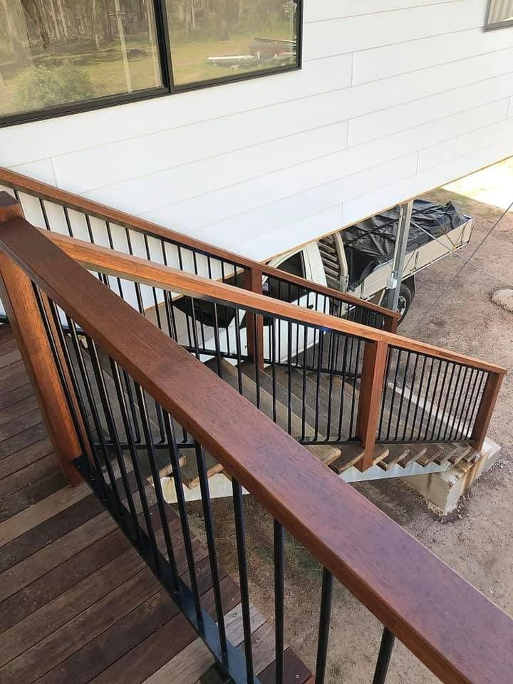 A Wooden Deck With Stairs and a Metal Railing — RBG Building & Maintenance in Veteran, QLD