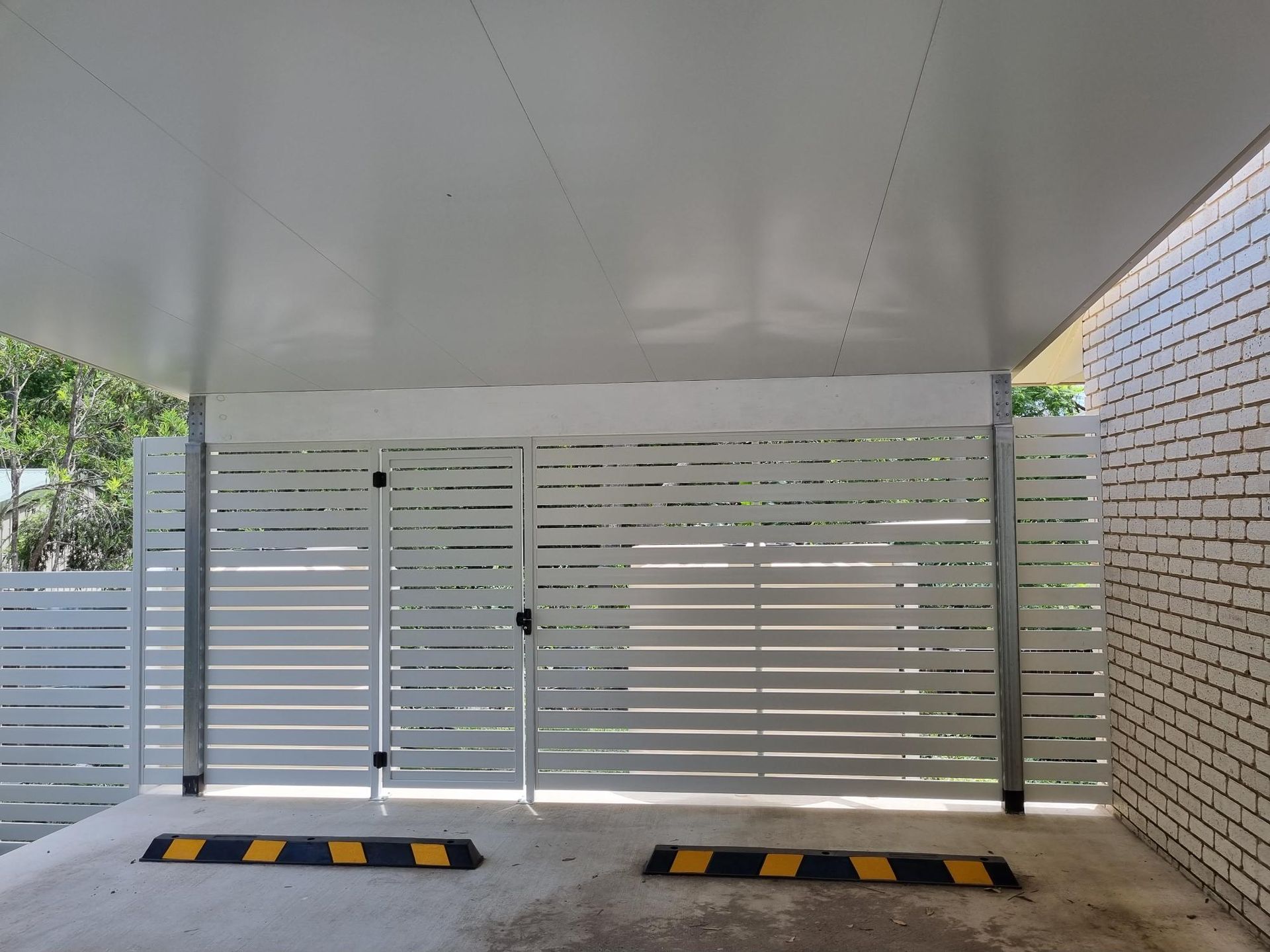 A Wooden Fence is Surrounded by Grass — RBG Building & Maintenance in Veteran, QLD