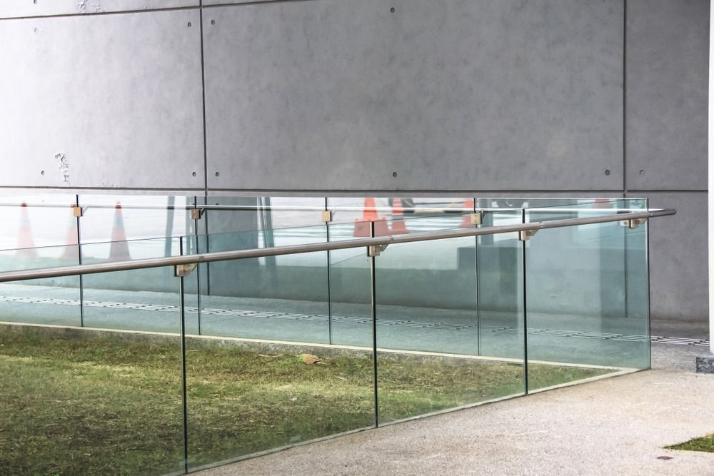 A Concrete Wall With a Glass Balustrading on It — RBG Building & Maintenance in Veteran, QLD