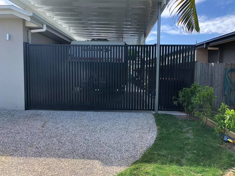 A White Fence Surrounds a Field of Dry Grass — RBG Building & Maintenance in Veteran, QLD