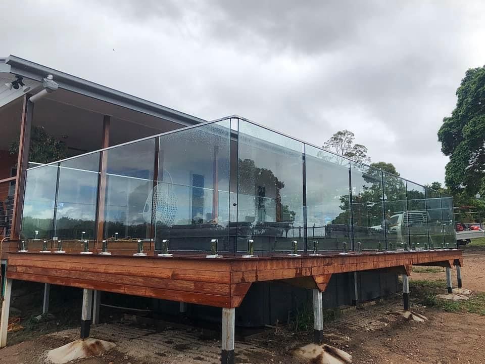 A Large Swimming Pool With Glass Fencing — RBG Building & Maintenance in Veteran, QLD