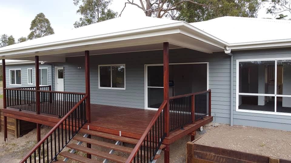 A Hot Tub is Sitting on Top of a Wooden Deck — RBG Building & Maintenance in Veteran, QLD