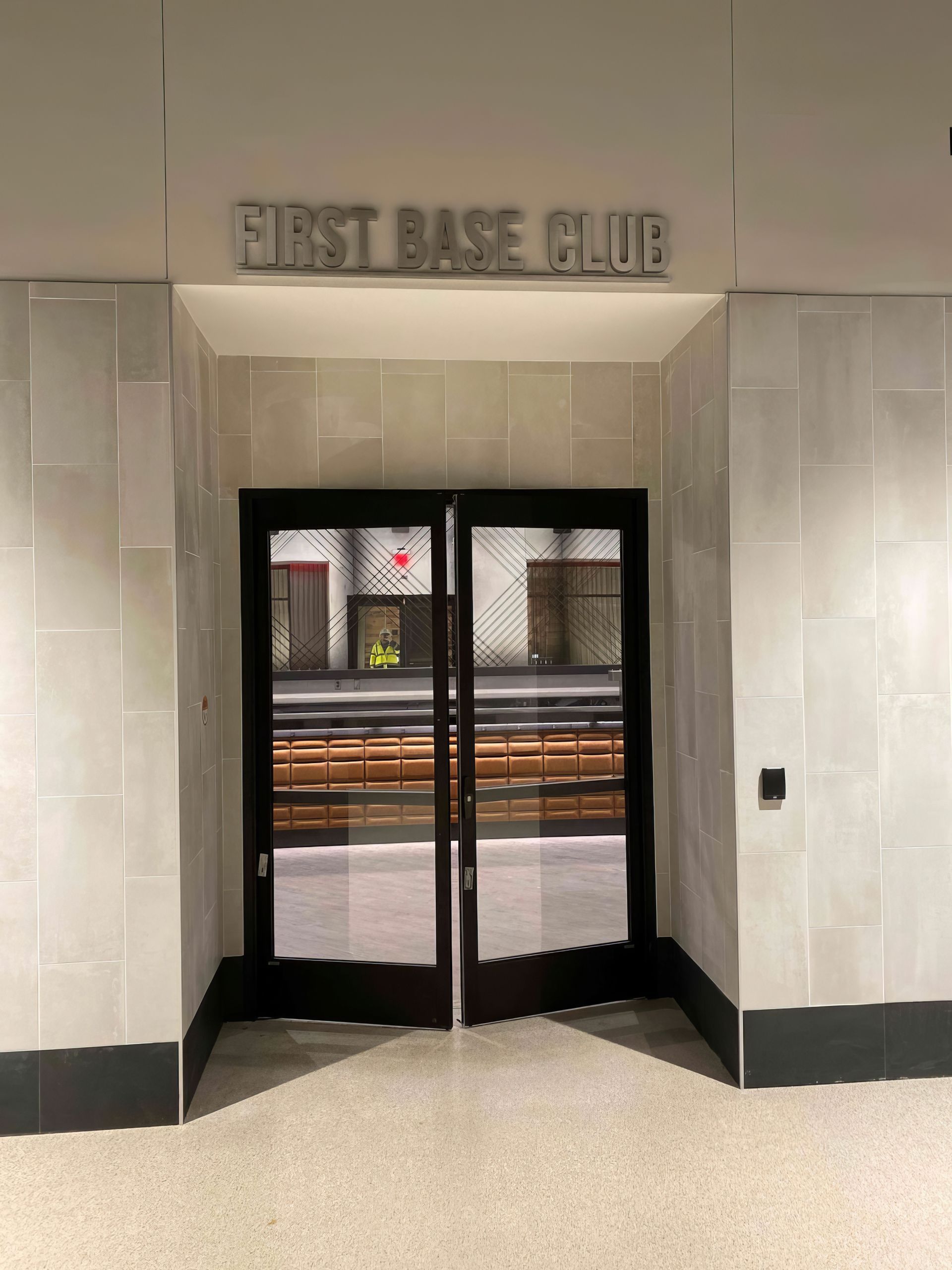 Entrance to First Base Club with double doors and a view of the snowy street outside