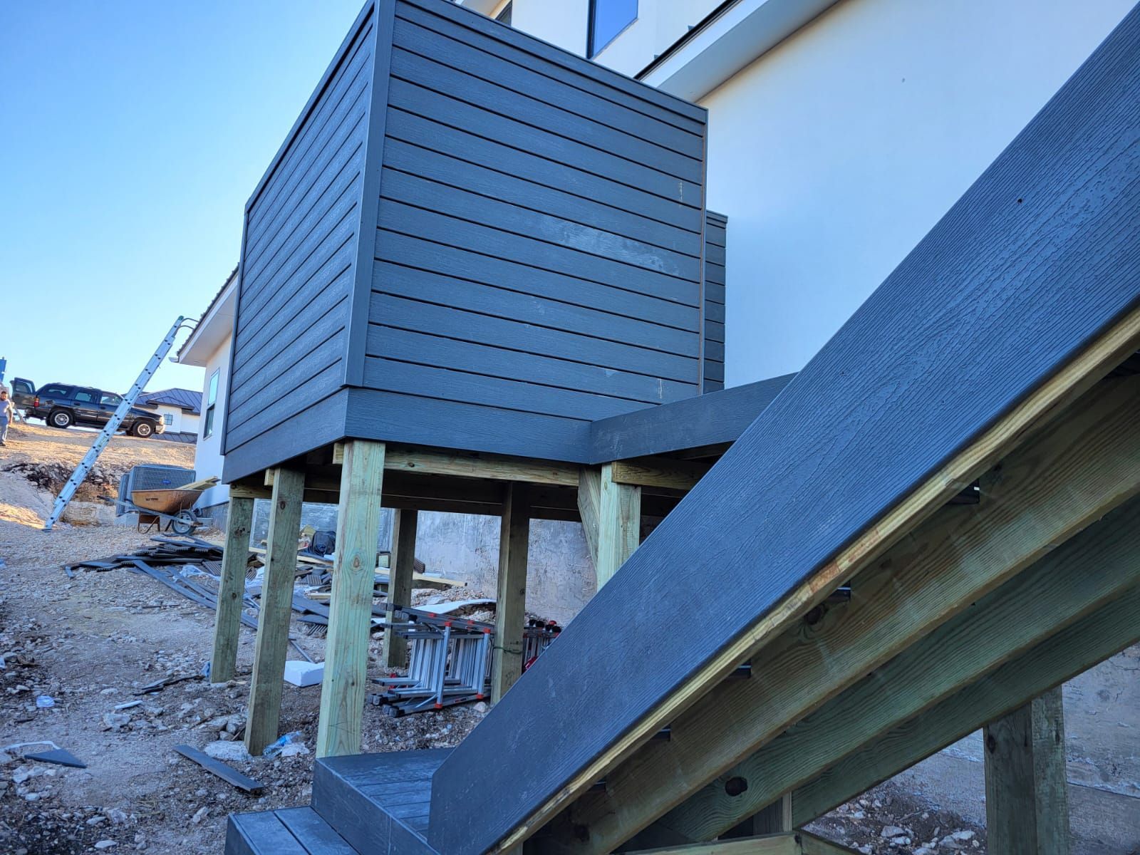A wooden deck with stairs leading up to it