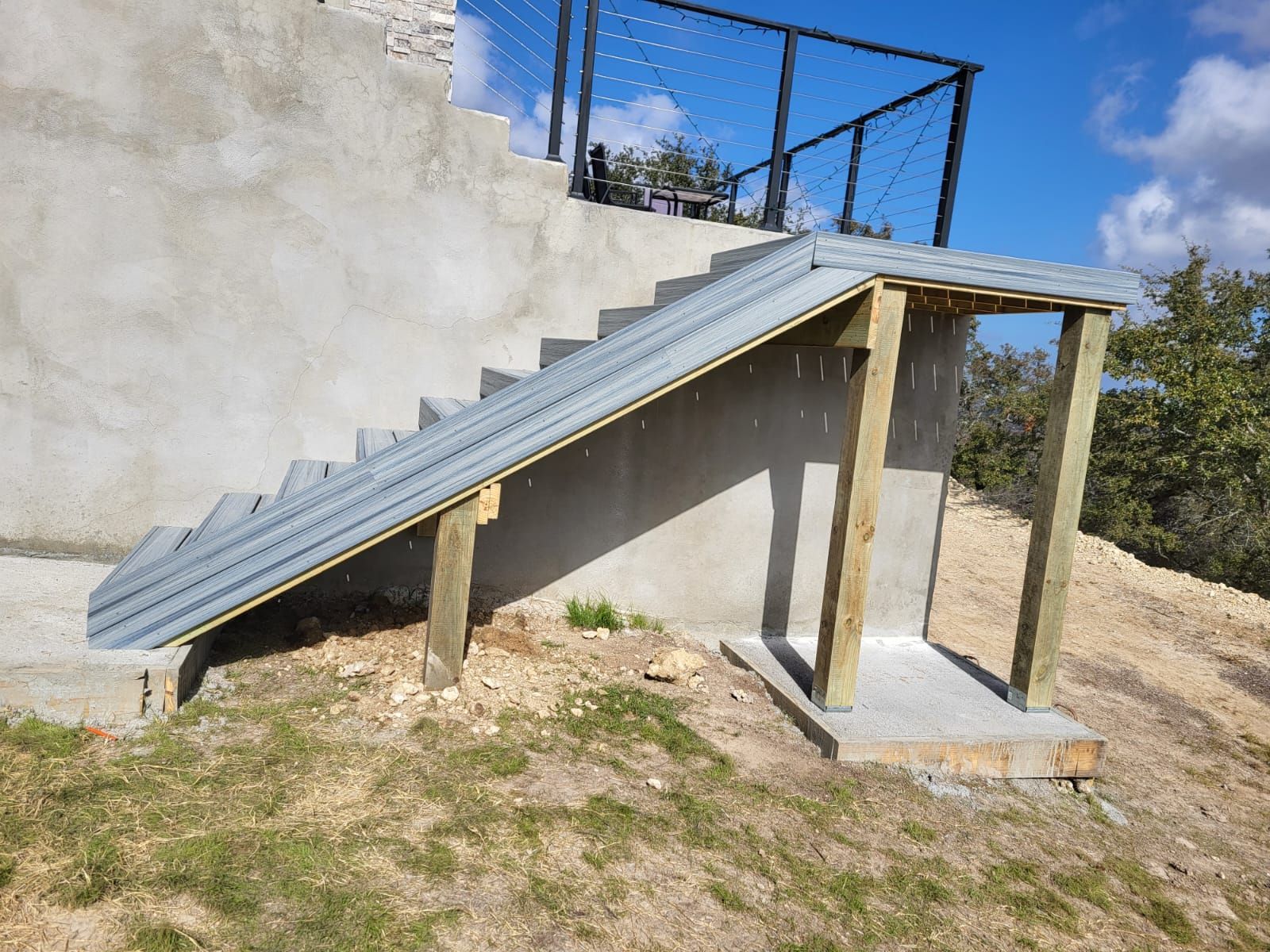 A set of stairs built into a wall with a metal railing.