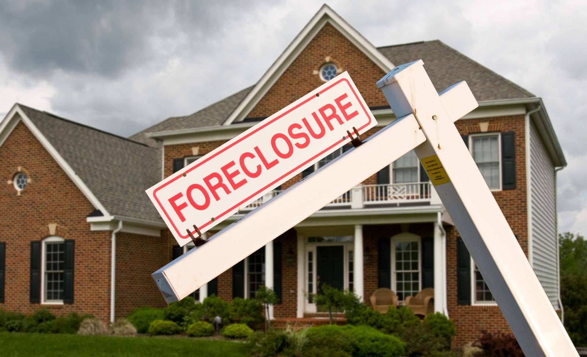 House with a “FORECLOSURE” sign in front yard
