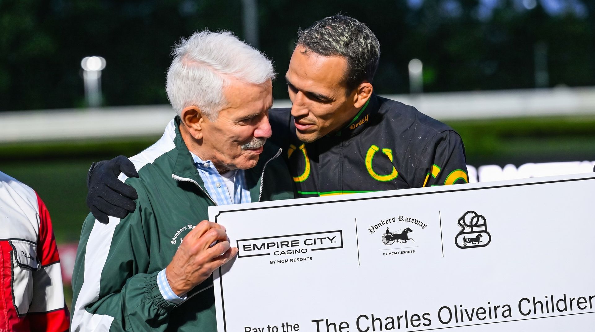 Standardbred Owners Association of New York President Joseph Faraldo presenting a $5,000 check to the Instituto Charles do Bronx to UFC fighter Charles 