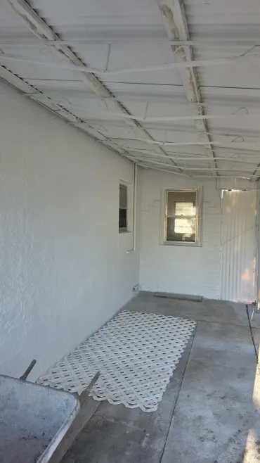 Empty beige room with brown carpet, ceiling light, open door, and curtained window. Empty beige room with brown carpet, ceiling light, open door, and curtained window.