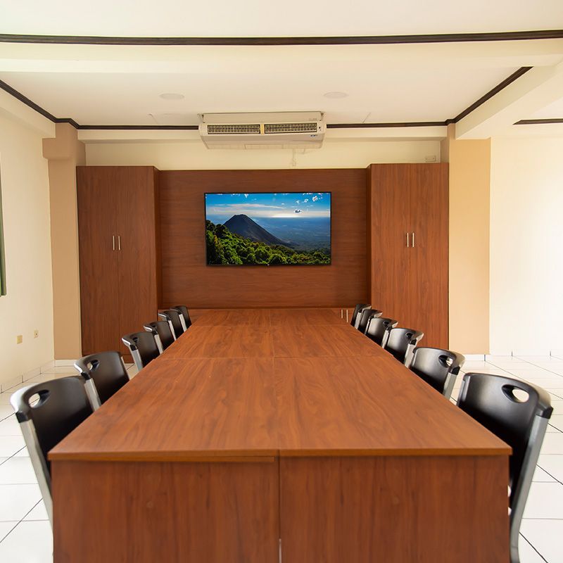 A conference room with a long wooden table and chairs