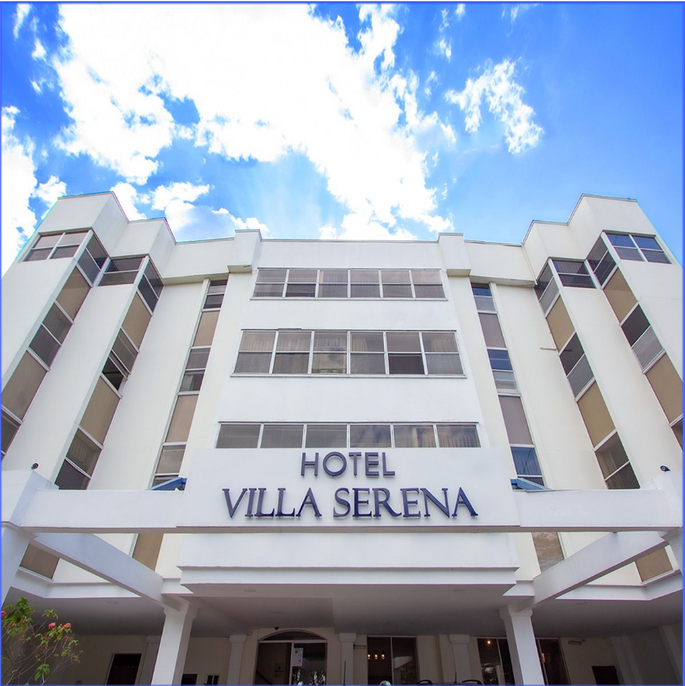 Looking up at the hotel villa serena with a blue sky in the background