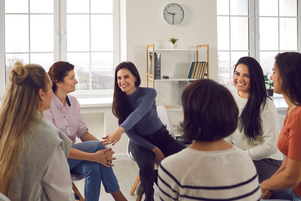 A Group Of Women Are Sitting In A Circle Talking To Each Other — The Therapists Cairns In Cairns City, QLD