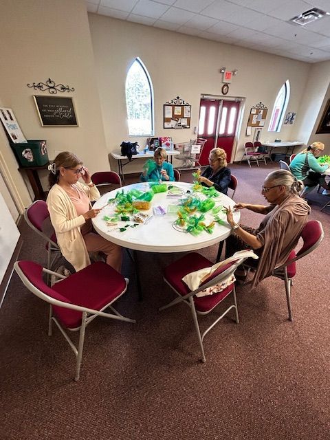 A group of people are sitting around a table in a room