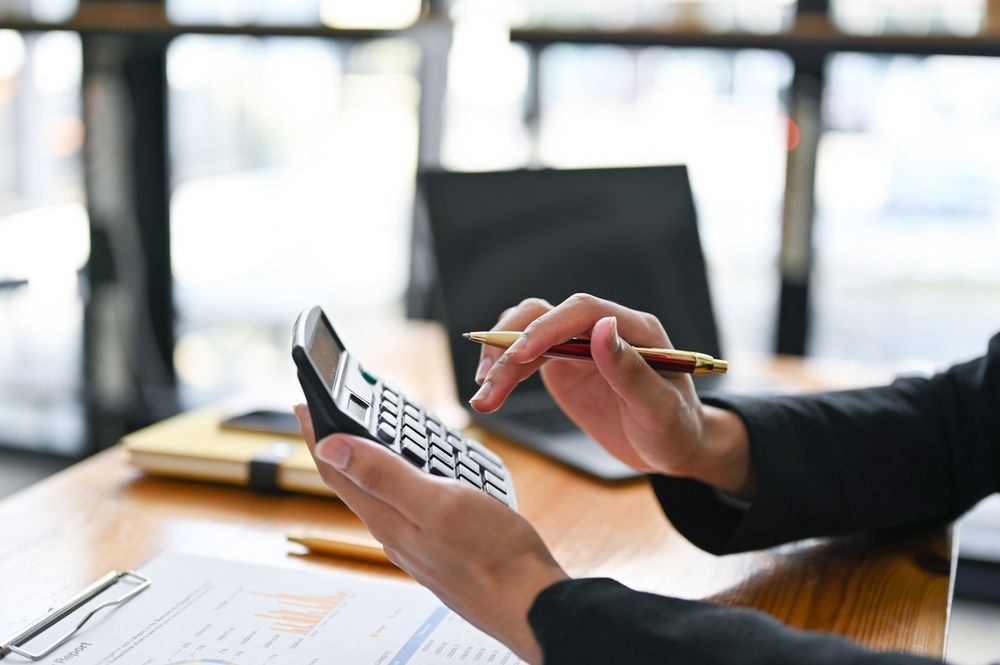 Female Accountant Conducting Computations Using A Pen And Calculator — Dynamic Accounting Taxation Advisors in Terrigal, NSW