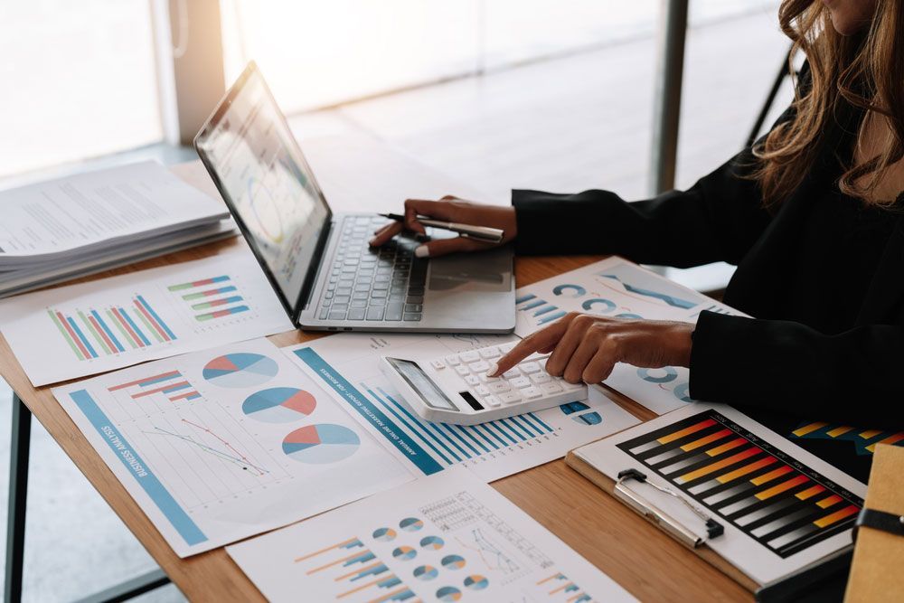 Bookkeeper Analysing And Calculating Financial Figures — Dynamic Accounting Taxation Advisors in Kincumber, NSW