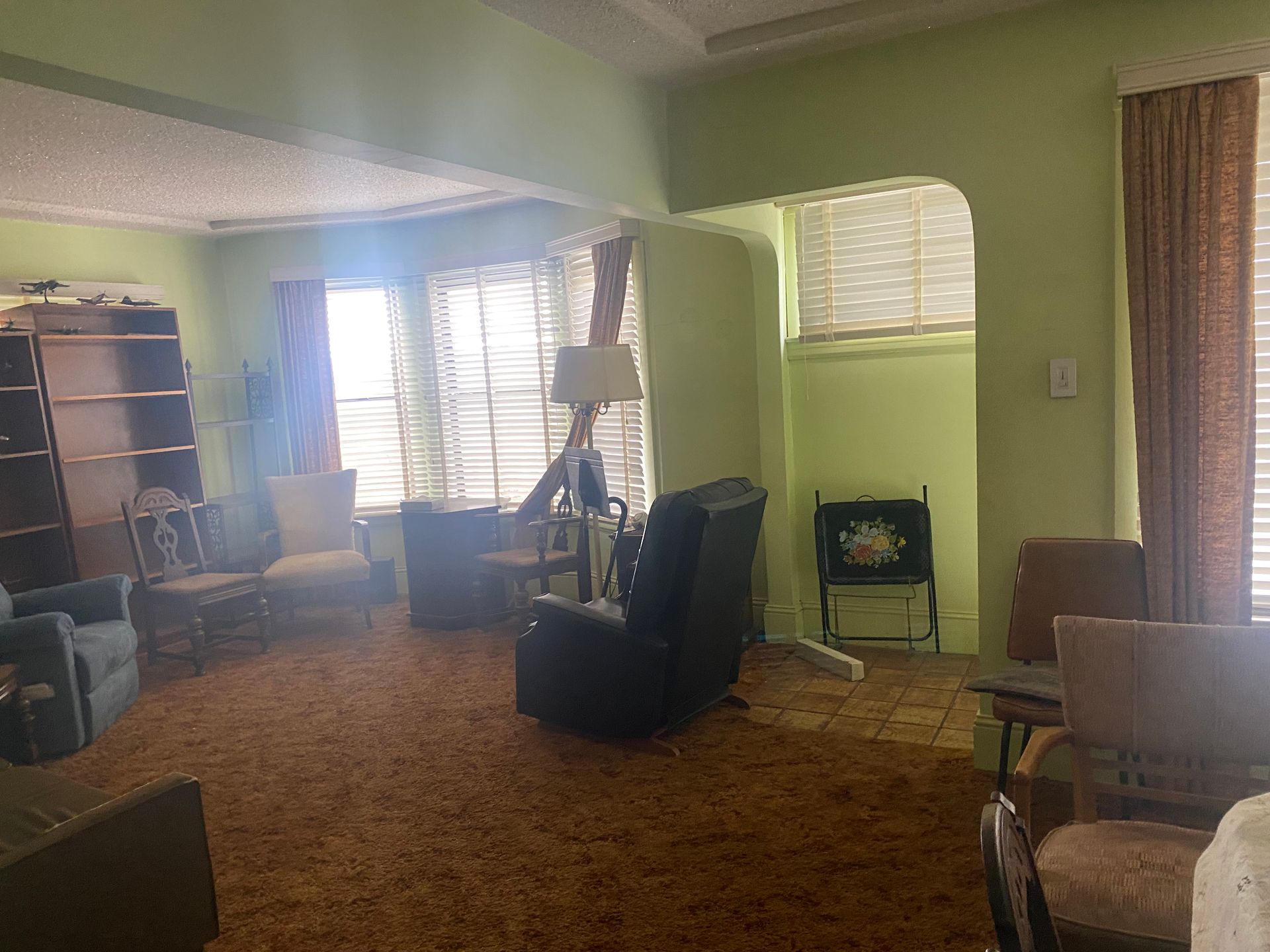 A living room filled with furniture and a lamp.