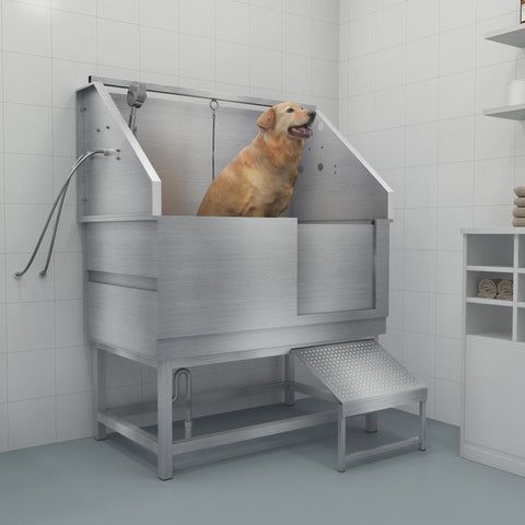 Golden retriever standing in a stainless steel dog grooming tub in a white tiled room
