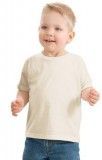 A little boy wearing a white t-shirt and blue jeans is standing on a white background.