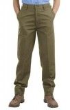 A man wearing khaki pants and brown shoes is standing with his hands in his pockets.