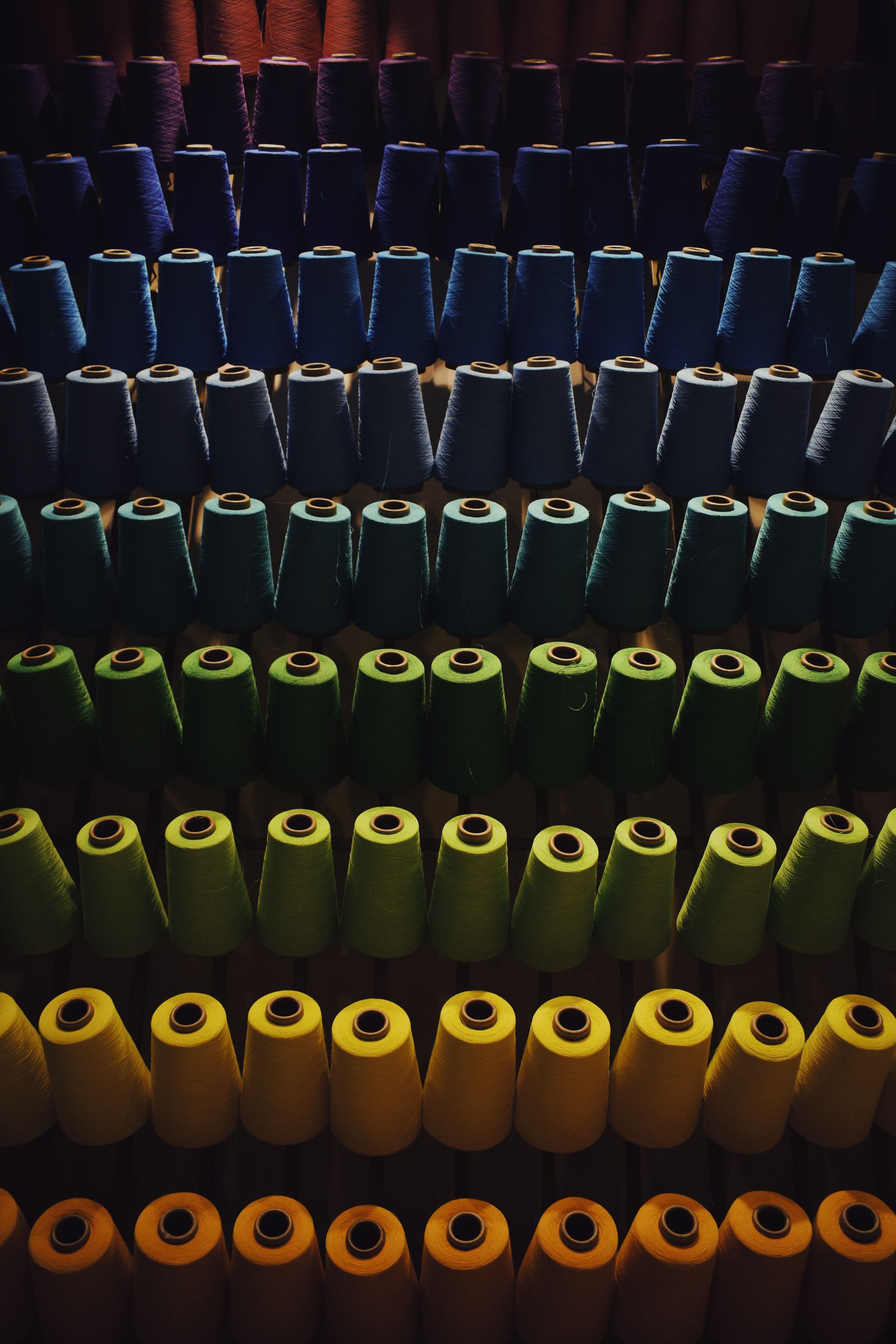 A row of colorful cups are lined up in a row
