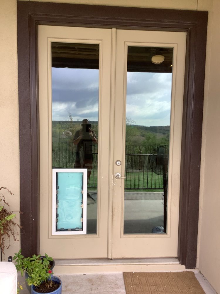 A door with a dog door attached to it.