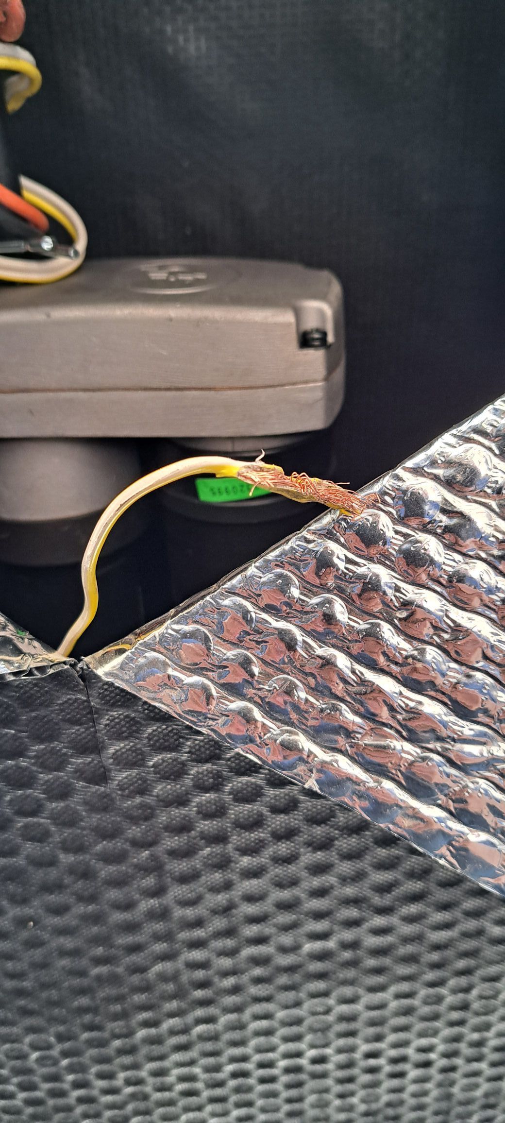A close up of a wire connected to a device on a table.