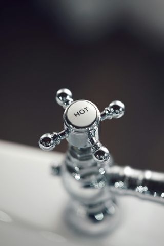 A close up of a faucet with the word hot on it