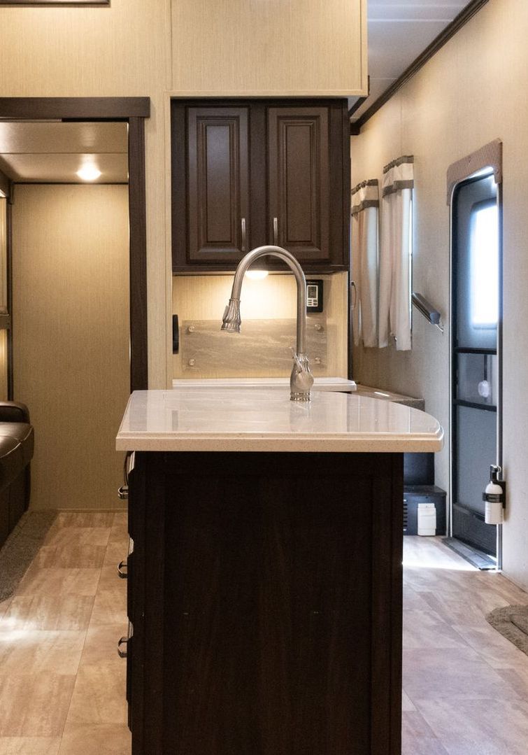 A kitchen with a large island and a sink