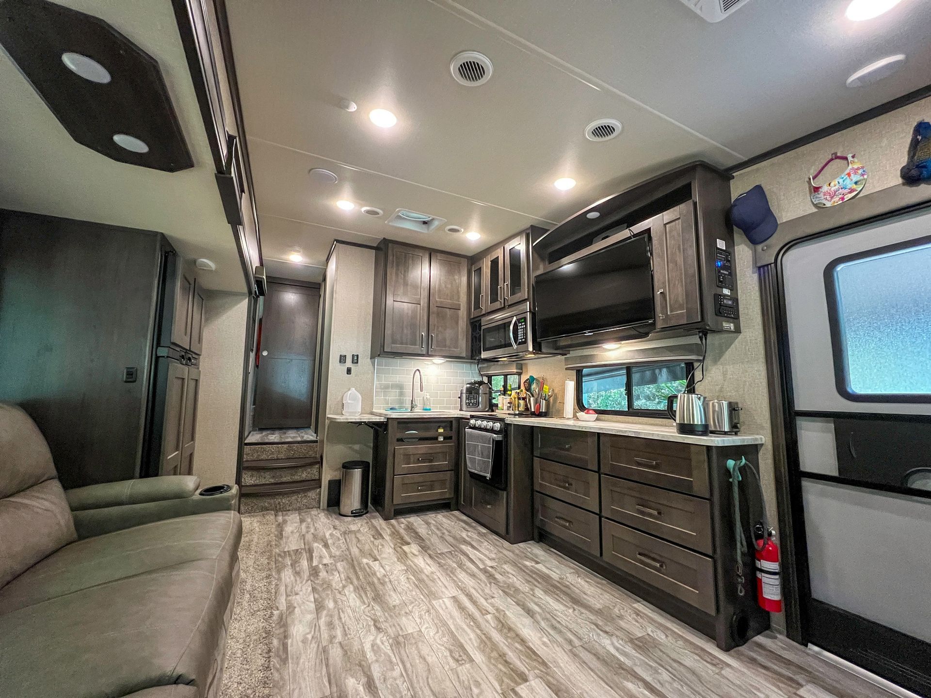 A living room with a couch and a kitchen in a rv.
