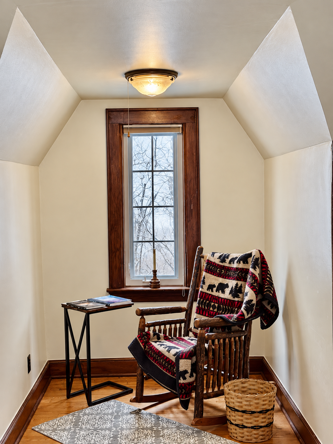 Bright upstairs reading nook at Red Fox Townhouse featuring sloped ceilings and wood-trimmed window.