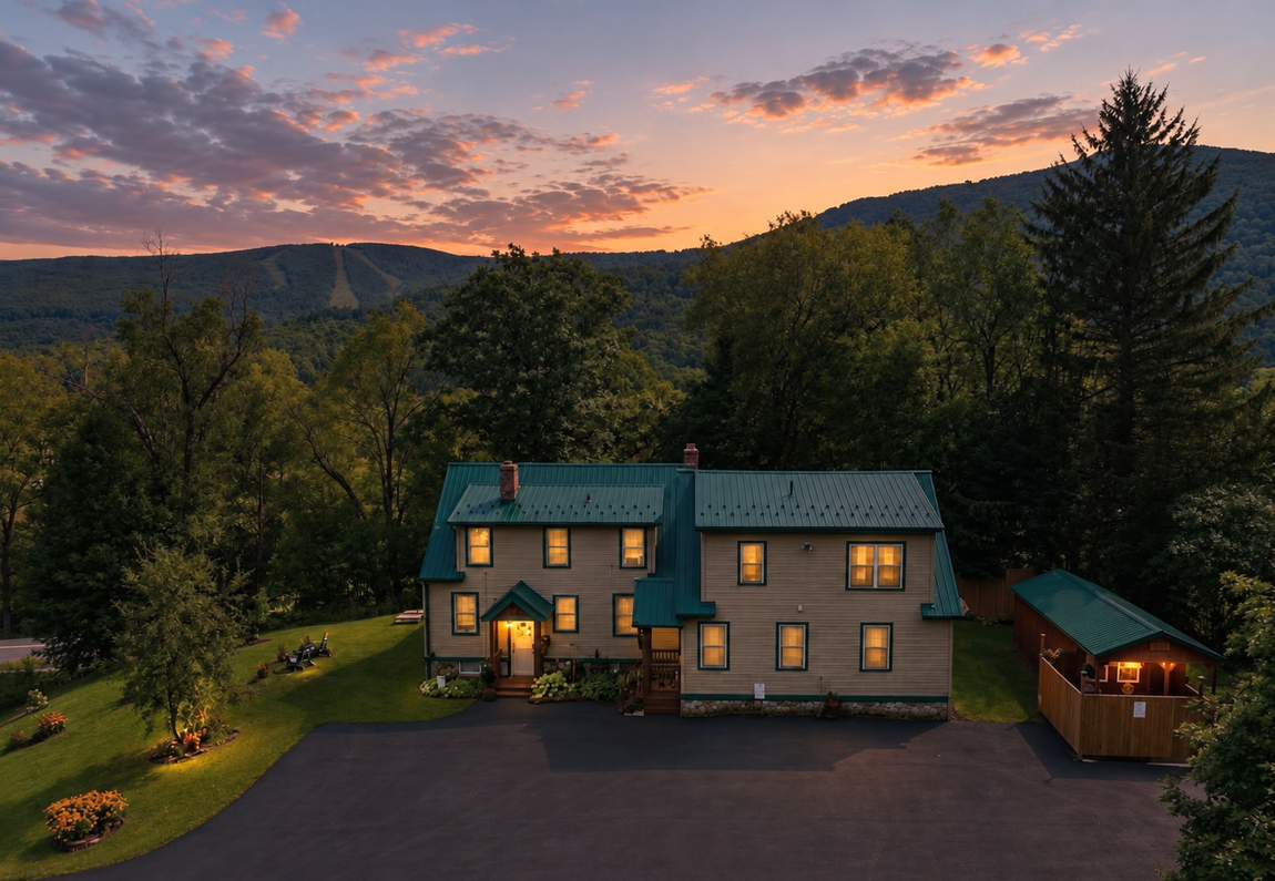 Red Fox Townhouse at sunset in Windham, NY, surrounded by Catskill Mountain views and wooded scenery.