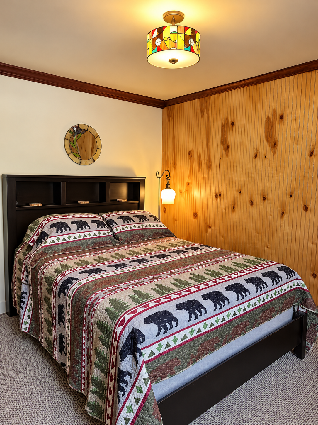 Cozy interior of the Red Fox Townhouse featuring natural wood paneling, warm lighting and rustic Catskills decor.