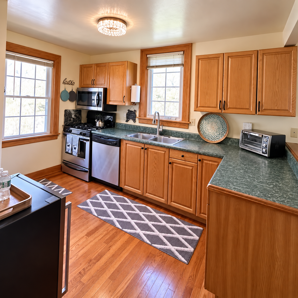 Fully equipped Red Fox Townhouse kitchen with wooden cabinets, stainless steel appliances and natural light in Windham, NY.