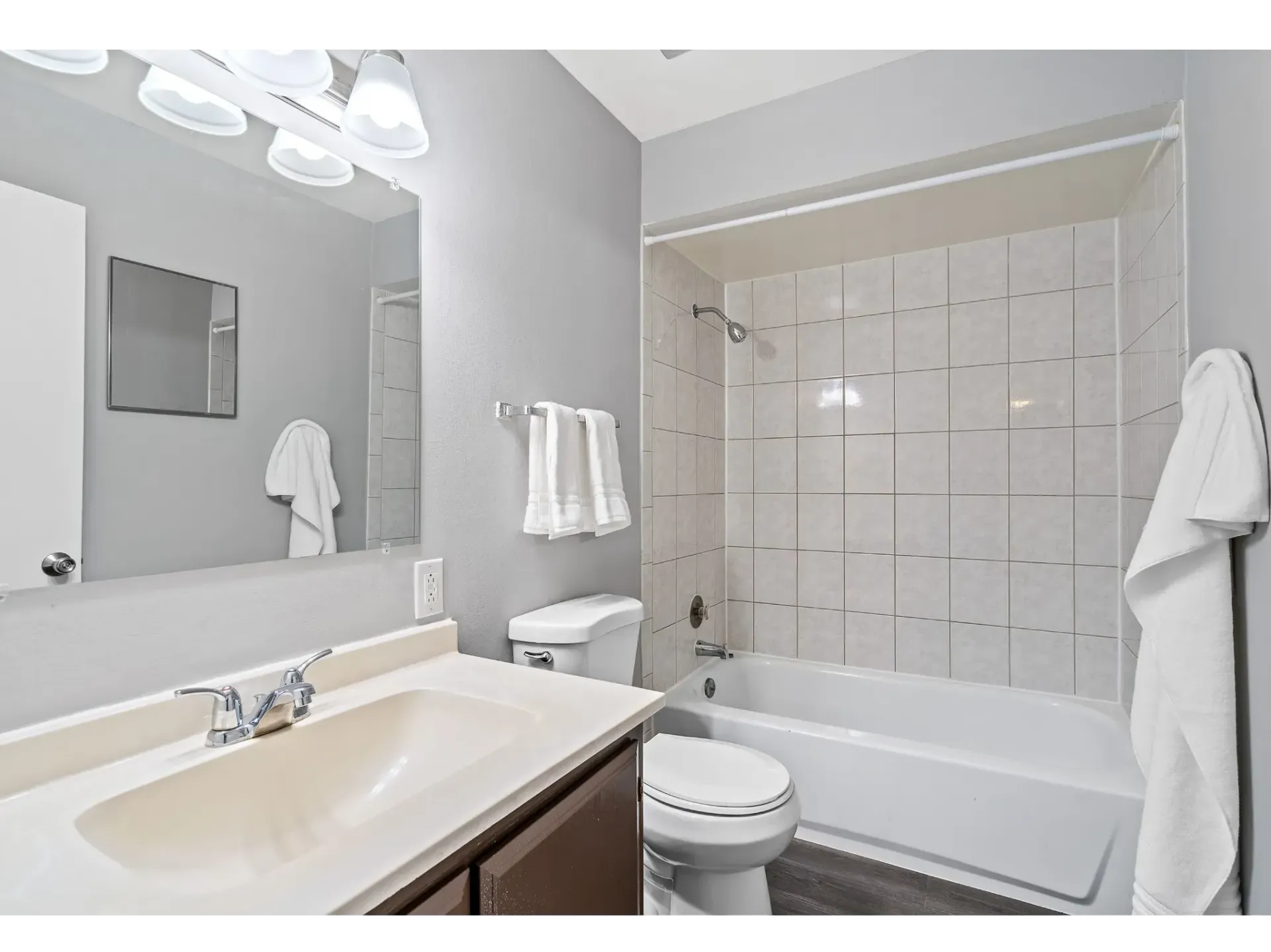 Modern bathroom featuring a sink, toilet, and bathtub with shower.