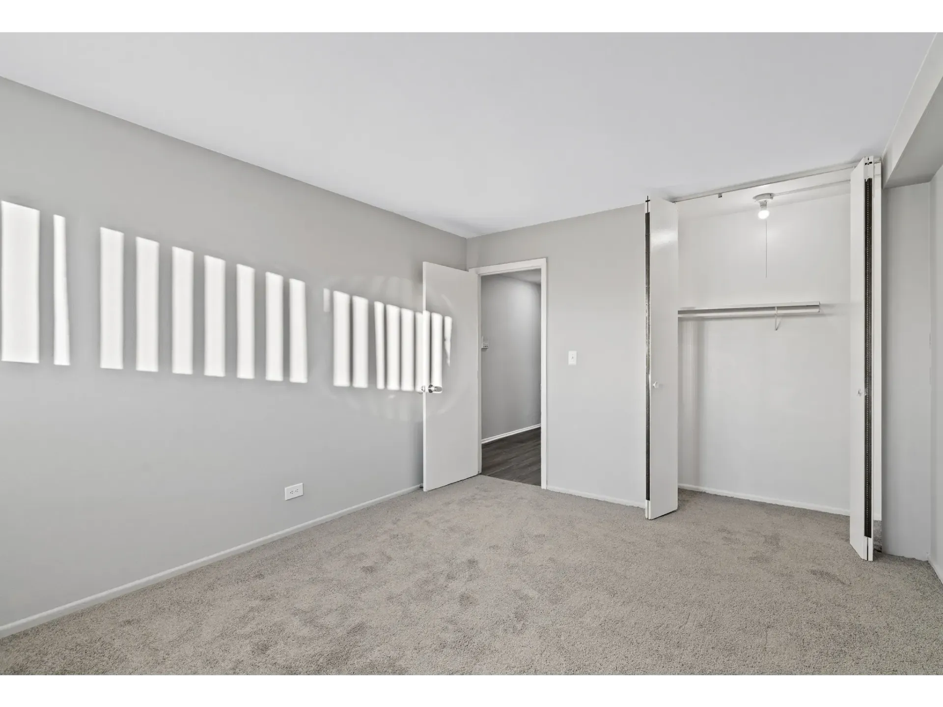 Spacious bedroom with natural light and closet