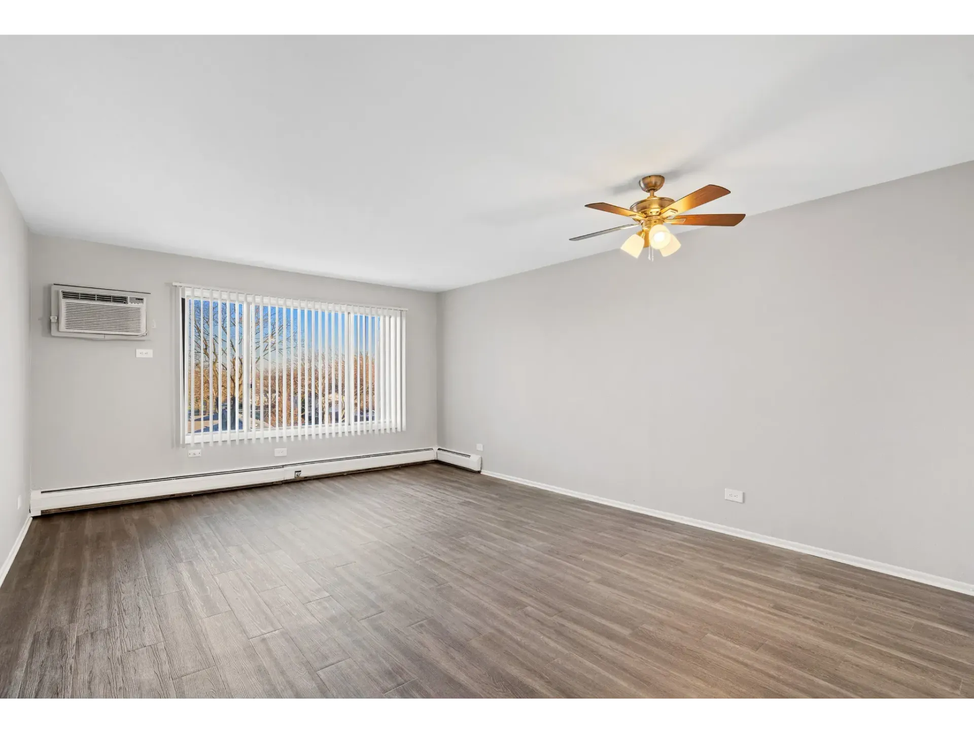 Spacious living room with ceiling fan and large window
