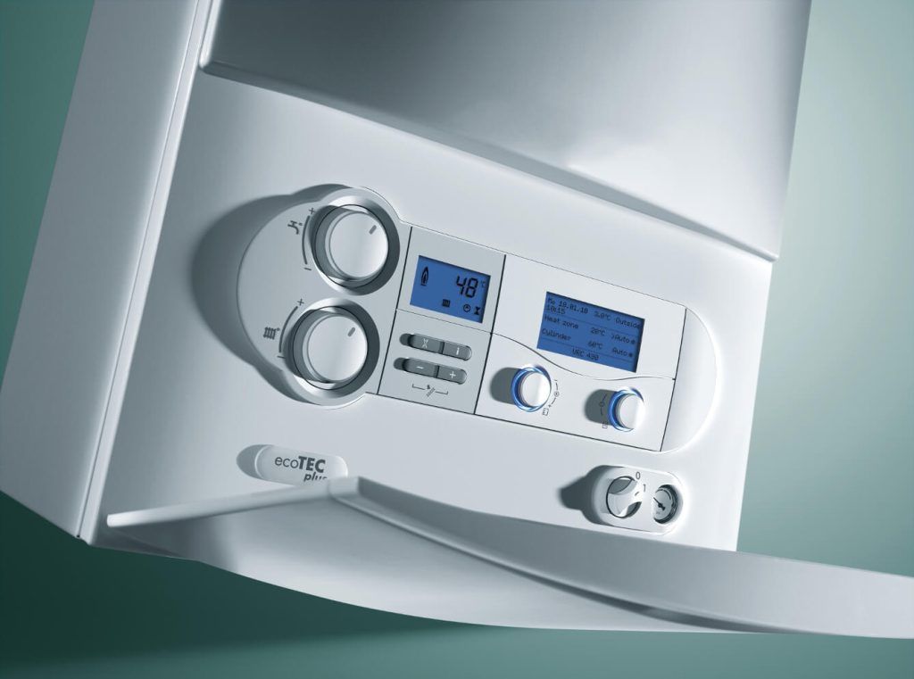 A close-up of a white wall-mounted boiler control panel with digital displays, circular adjustment knobs, and buttons.
