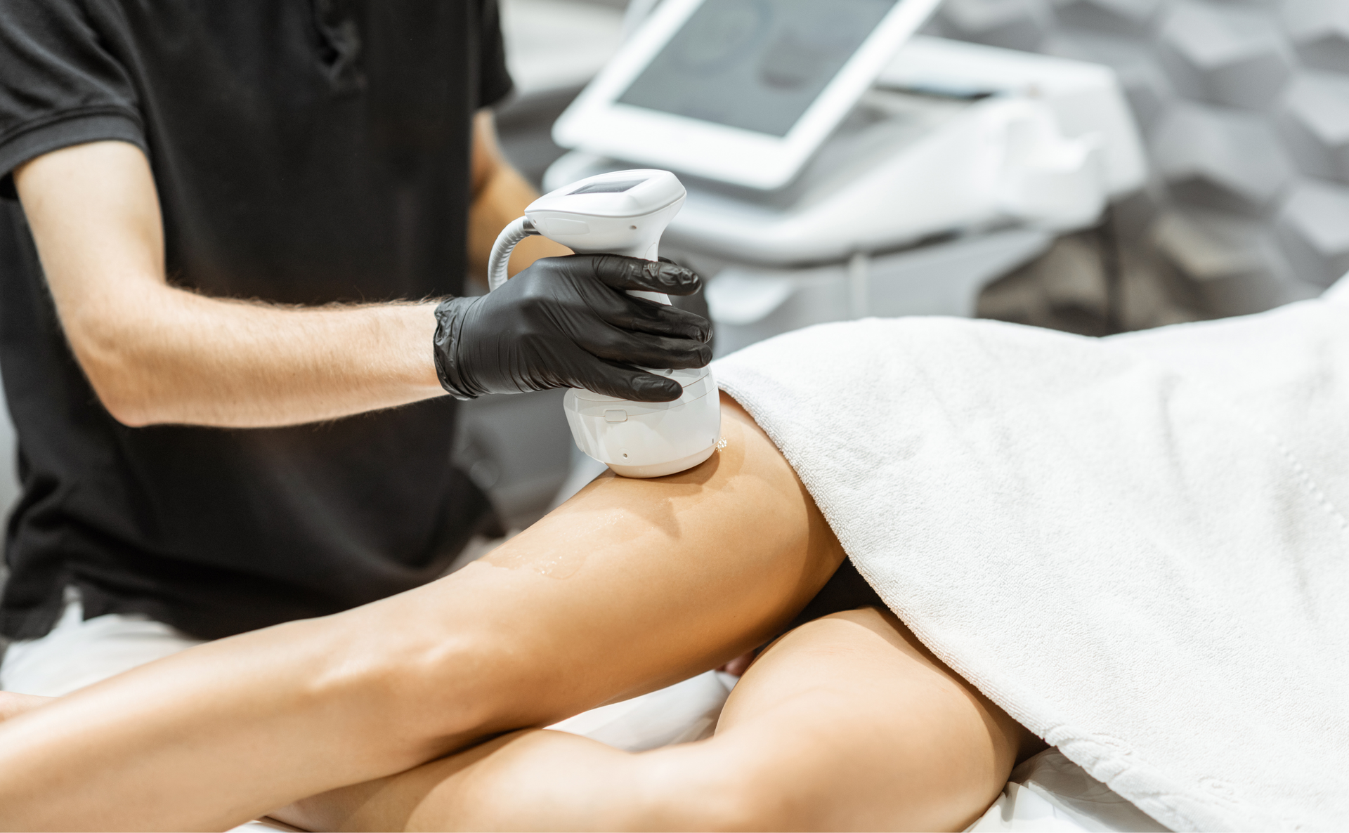 A woman is getting a treatment on her leg in a spa.