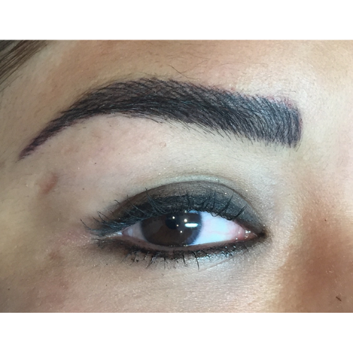 A close up of a woman 's eye with makeup on.