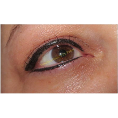 A close up of a woman 's eye with eyeliner on it.