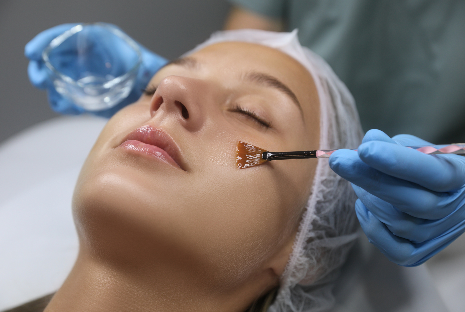 A woman is getting a facial treatment at a beauty salon.