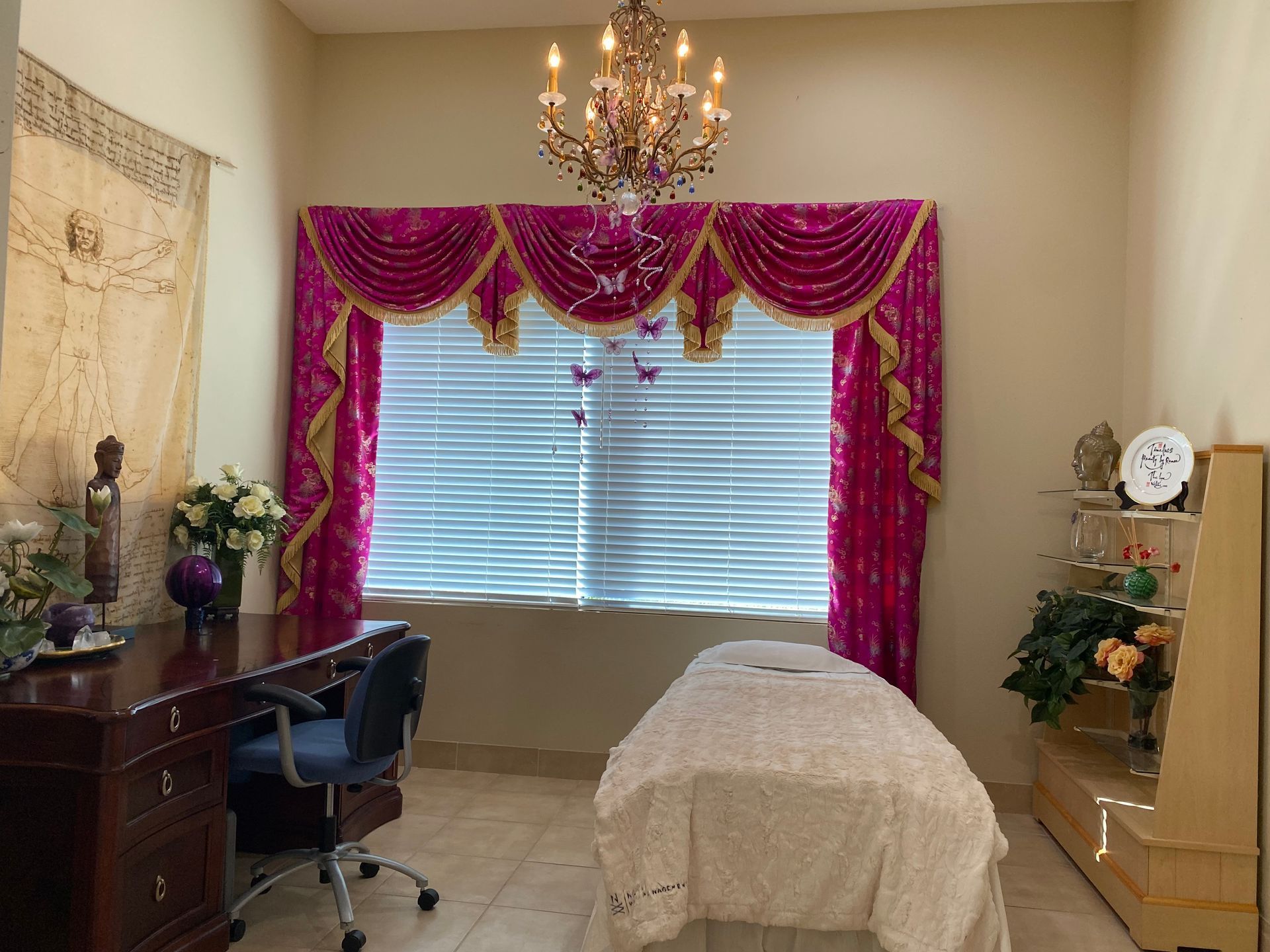 A room with a massage table and a chandelier