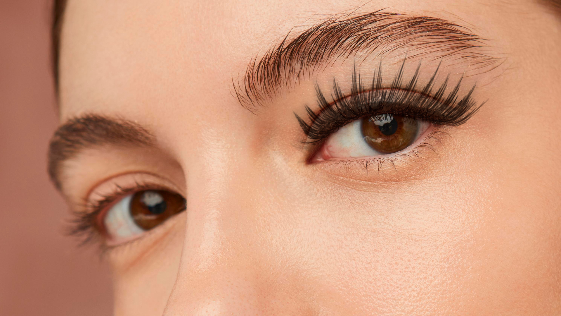 A woman is getting eyelash extensions in a beauty salon.