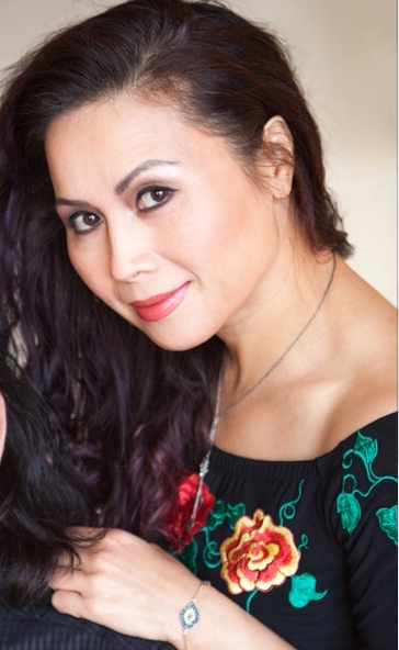 A woman wearing a black dress with flowers on it