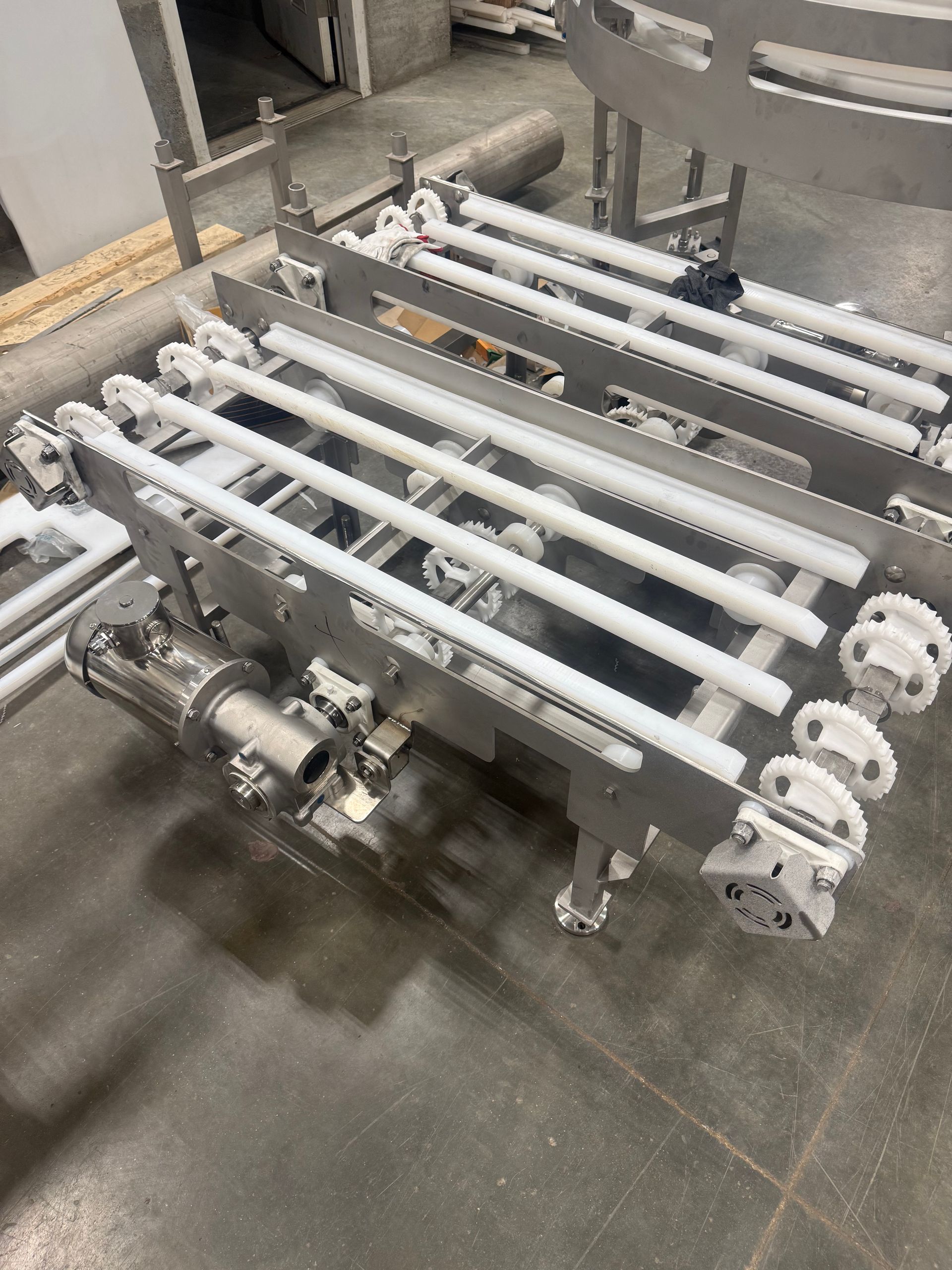 Industrial metal conveyor rollers on a factory floor