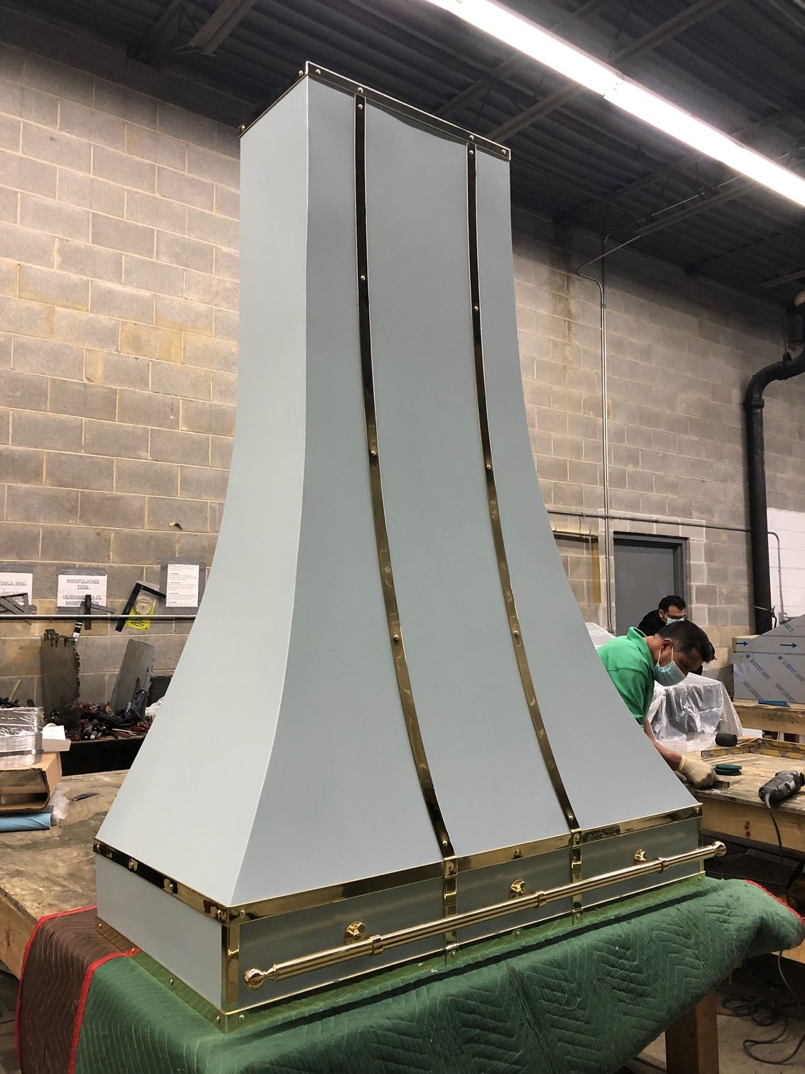 A white and gold hood is sitting on a table in a room.