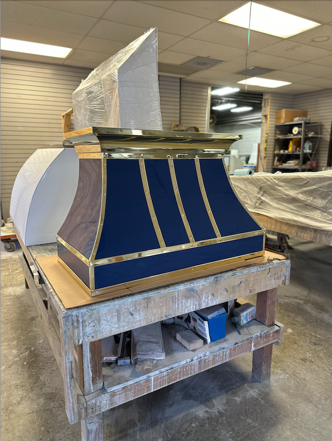 A blue and gold hood is sitting on a wooden table